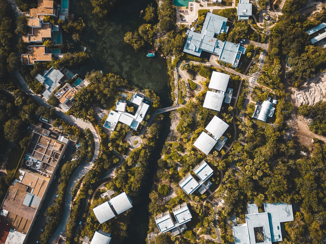 Stunning aerial view of a tropical resort in Playa del Carmen, showcasing lush greenery and vibrant architecture.